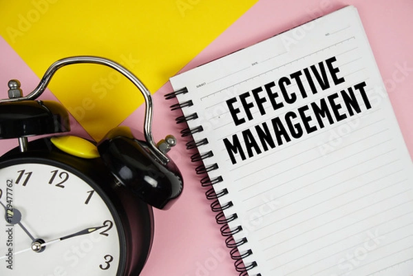 Obraz Effective Management text written on notepad with alarm clock on pink background