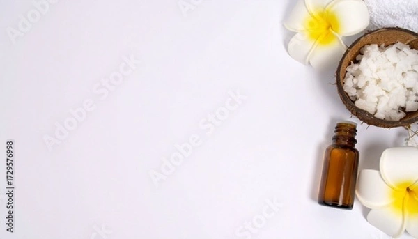 Fototapeta Flat lay of natural skincare ingredients: coconut oil, essential oils, and fresh coconut on white with copy space.