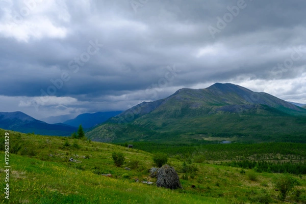 Fototapeta Landscape with mountains, small lake and coniferous forest cloudy summer day view from above