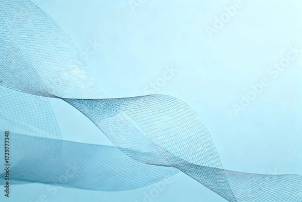Fototapeta Abstract flowing blue fabric with soft texture and gentle waves against a light background