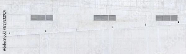 Fototapeta external concrete wall of the building with lattices of ventilation and lamps over a ramp for wheelchairs.