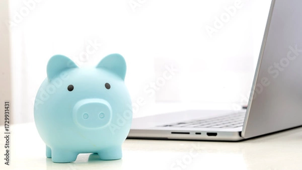 Obraz Piggy bank piggy bank on the table by the laptop