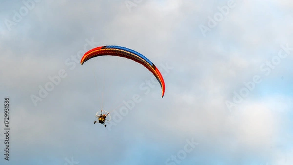 Obraz Moto glider with parachute on sunset background