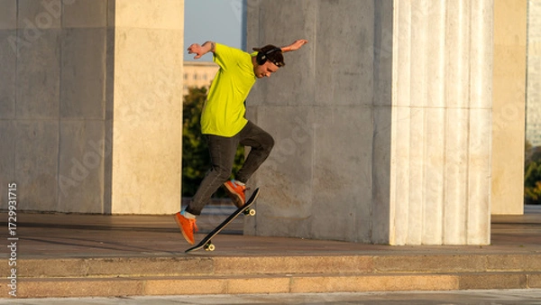 Obraz Skateboarder riding a skateboard and doing tricks