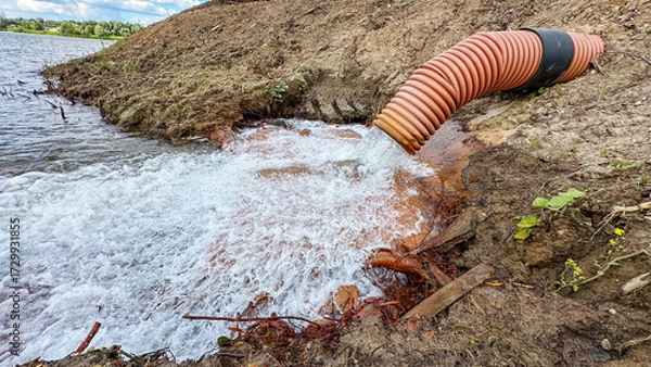Obraz Discharge of water into a reservoir from a pipe