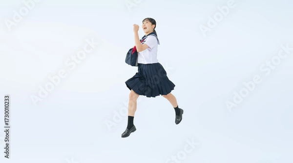 Obraz ジャンプするセーラー服を着た女子学生の切り抜き全身写真