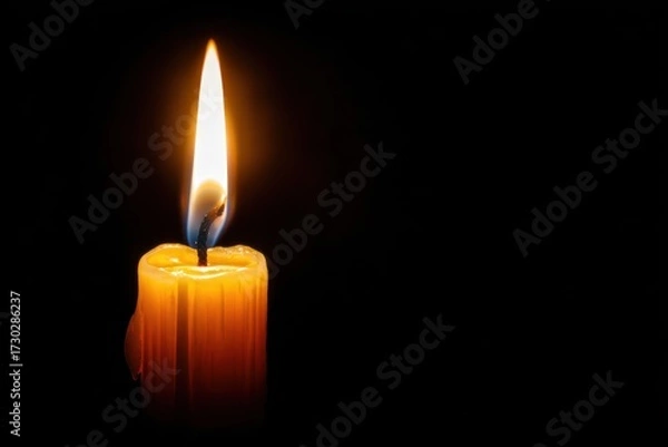 Fototapeta Bright Flame of a Single Candle with Dark Background for Serenity