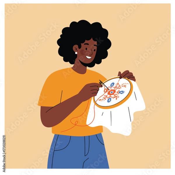Fototapeta Woman smiles while embroidering floral design on a round frame