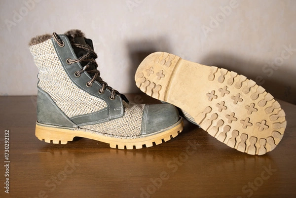 Fototapeta Side view of worn rustic boots made from nubuck leather and natural burlap fabric. Adventure and outdoor lifestyle concept
