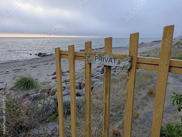 Fototapeta View of a private beach that was fenced off with a private sign early in the morning