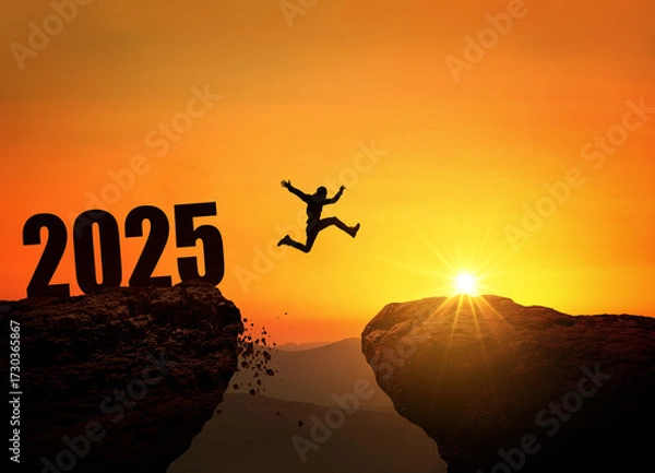 Fototapeta Silhouette of a person jumping across a cliff with the number 2025 at sunset. Concept of new year, challenge, success, goals, future opportunities, and overcoming obstacles.