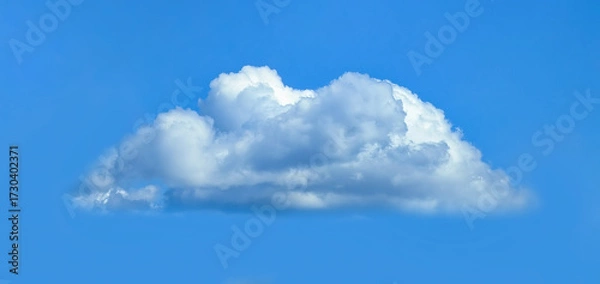 Fototapeta Low angle view of fluffy cumulus clouds against blue sky background.
