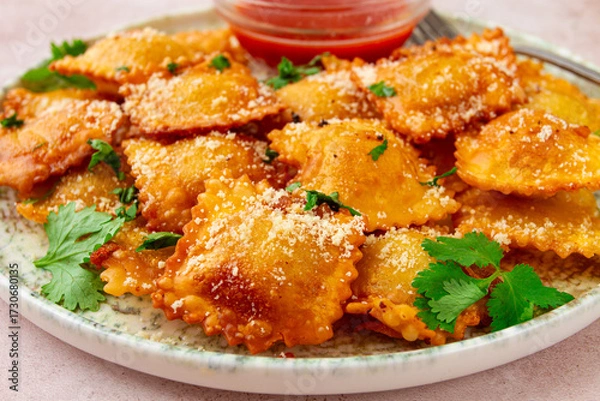 Obraz fried ravioli with parmesan cheese, served with red sauce and garnished with herbs, on a light background, no people,