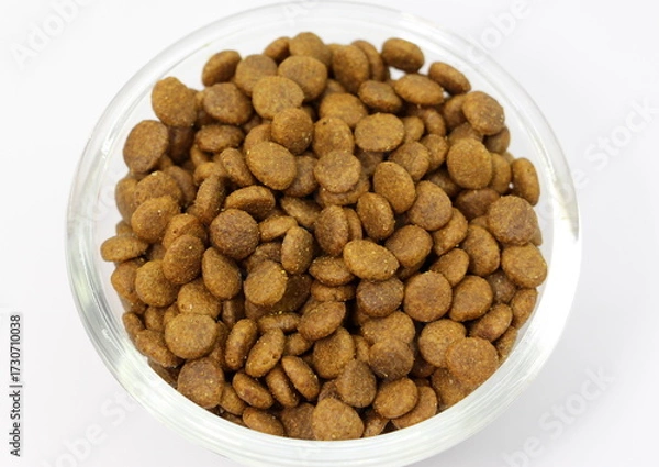 Fototapeta Dry balanced food for cats or dogs in a glass round bowl on a white background isolated. Top view