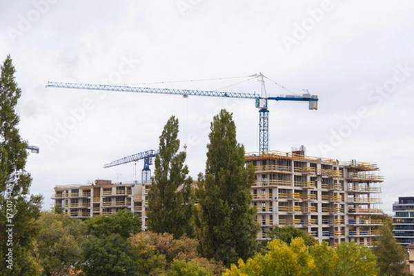 Fototapeta Building construction with crane in the city