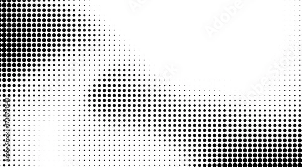 Fototapeta This image showcases a dynamic black and white halftone pattern, with varying density of black dots creating a gradient effect against a clear, bright white background, ideal for modern designs