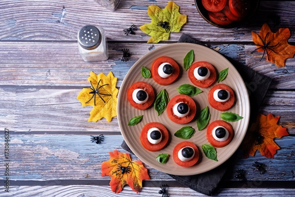 Fototapeta Caprese salad in the form of eyes of monster in a plate for Halloween holidays