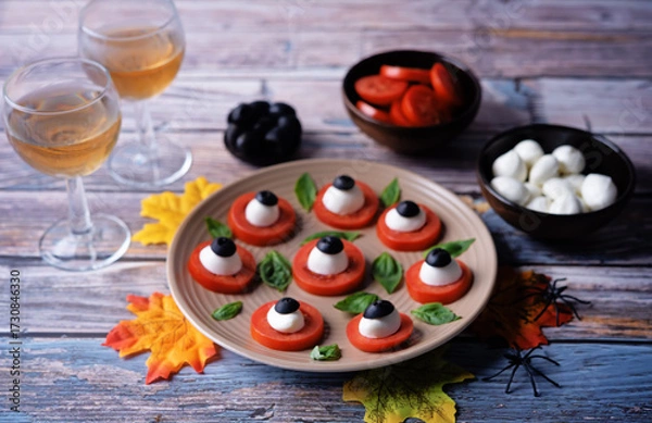Fototapeta Caprese salad in the form of eyes of monster in a plate for Halloween holidays