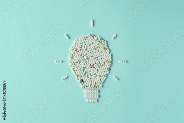 Fototapeta Creative light bulb shape made of white plastic blocks on pastel background symbolizes new ideas, innovation, inspiration and creative thinking.