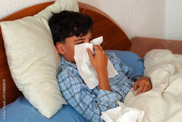 Fototapeta Child Health and Well-Being Concept – Sick Child in Pajamas with mucus and a tissue in hand