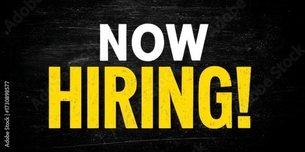 Fototapeta now hiring text in bold white and yellow capital letters on black chalkboard-style background with high contrast and minimal composition for recruitment announcement