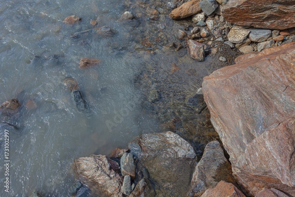 Fototapeta Contact between transparent water and cloudy water in a glacial stream, Alto Adige, Italy