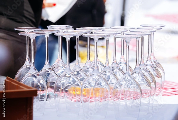 Fototapeta Elegant arrangement of wine glasses on a table, showcasing their crystal clarity and reflecting light, ideal for event planning and catering services