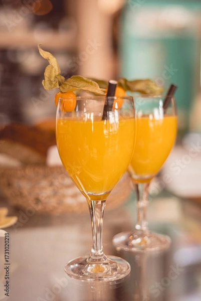 Fototapeta Bright tropical cocktails in elegant glasses create a refreshing atmosphere at a lively cafe during a sunny afternoon gathering