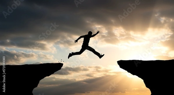 Fototapeta Silhouette of a person jumping over a chasm against dramatic sky
