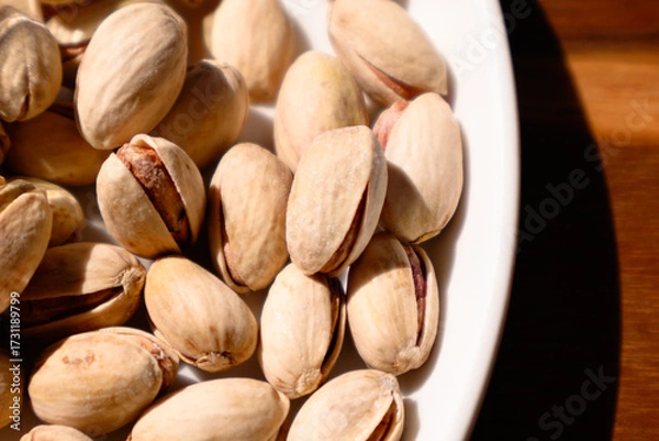 Obraz pistachio nuts on wooden table