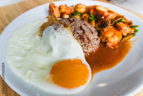 Obraz Delicious Stir-fried shrimp with chili, fried egg and brown rice as Thai food close-up