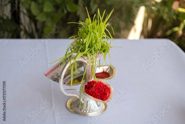 Fototapeta Tika and Jamara placed in a silver utensil with barley sprouts, money, and fruits for the Vijaya Dashami ceremony during Dashain festival in Nepal.
