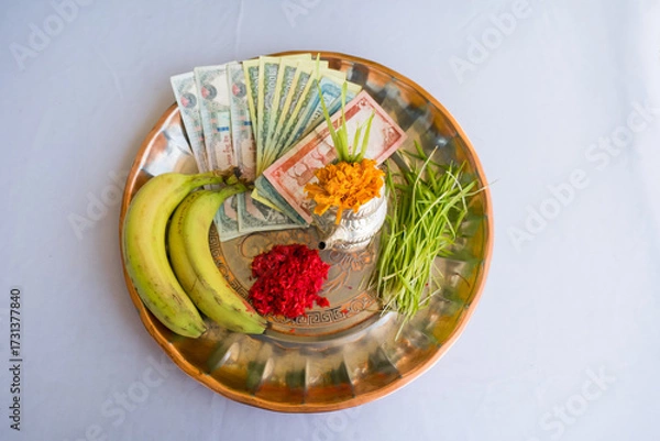Fototapeta Tika and Jamara placed in a silver utensil with barley sprouts, money, and fruits for the Vijaya Dashami ceremony during Dashain festival in Nepal.