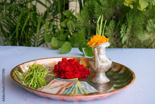 Fototapeta Tika and Jamara placed in a silver utensil with barley sprouts, money, and fruits for the Vijaya Dashami ceremony during Dashain festival in Nepal.