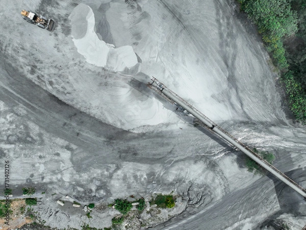 Fototapeta Aerial view of granite and limestone crushing plant with excavators processing raw stone into construction aggregates for concrete and infrastructure development. Stone mill factory.