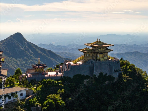 Fototapeta Golden temple stands proudly on Dahong Mountain, Suizhou, China, overlooking vast green valleys under a bright sky.