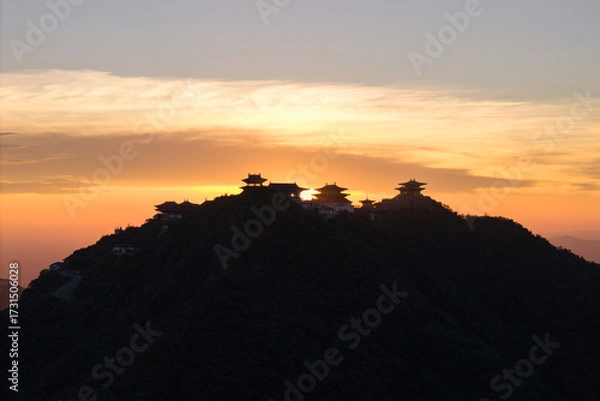 Fototapeta Dahong Mountain structures rise against a soft sky during sunrise, showing the peaceful setting of Suizhou, China.