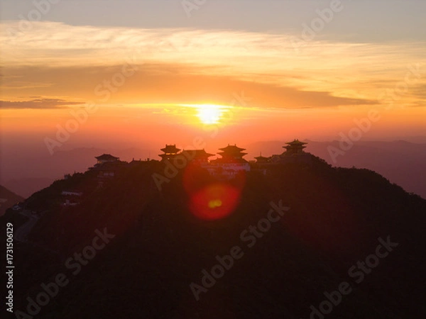 Fototapeta Dahong Mountain sunrise over Suizhou, China shows temples on a mountain crest.