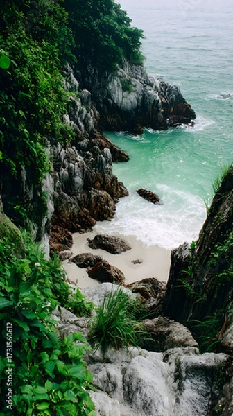 Fototapeta beach with clear turquoise water and pristine white sand framed by lush vegetation and rocks