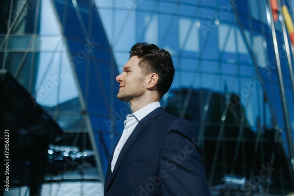 Fototapeta Side Portrait of Stylish Man in Suit Smiling in the City