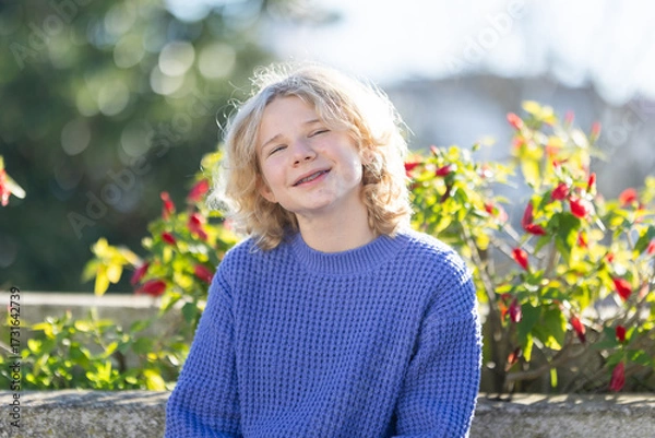 Fototapeta Young boy smiling wearing dental braces outdoors