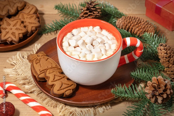 Fototapeta Warm holiday cocoa with marshmallows and festive cookies on a cozy wooden table