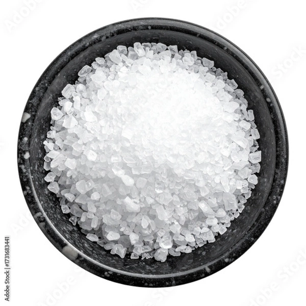 Fototapeta Macro closeup of white sea salt crystal powder in a clear glass bowl on a wood kitchen surface