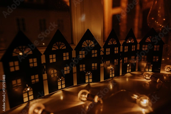 Fototapeta Windowsill Decorated With Fairy-Tale Houses And Shining Garland. Cozy Atmosphere