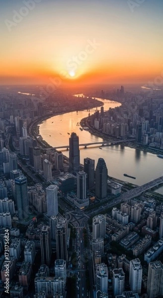 Fototapeta Urban sunrise over metropolis skyline reflecting on river panorama view