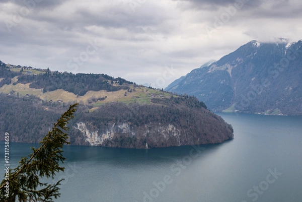 Obraz Cloudy Day View of Swiss Lake and Steep Mountain Shoreline