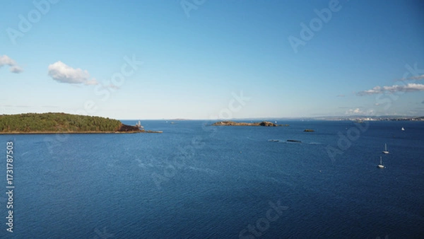 Fototapeta Wide panoramic view of the Firth of Forth, featuring Inchcolm Island and its famous Abbey. Captured from the scenic coastline of Dalgety Bay, Fife, Scotland.