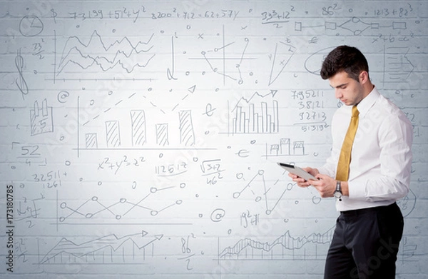 Fototapeta Salesman standing with drawn graph charts