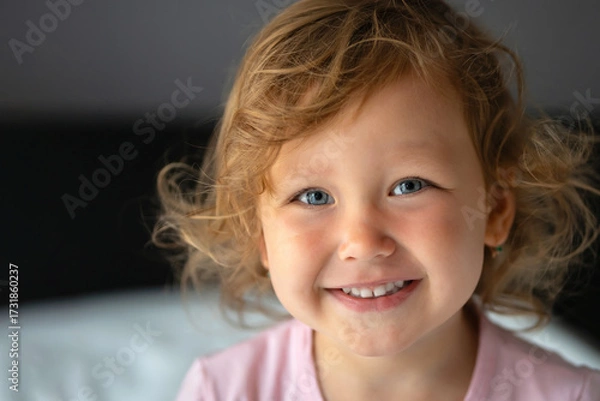 Obraz Portrait of smiling blond girl with blue eyes showing happiness