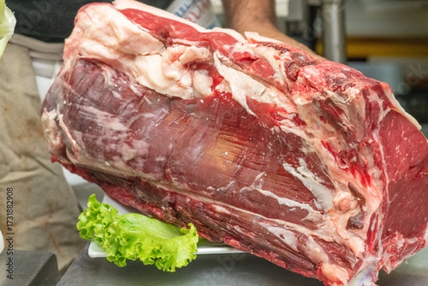Fototapeta Fresh meat selection showcasing different cuts in a professional kitchen setting